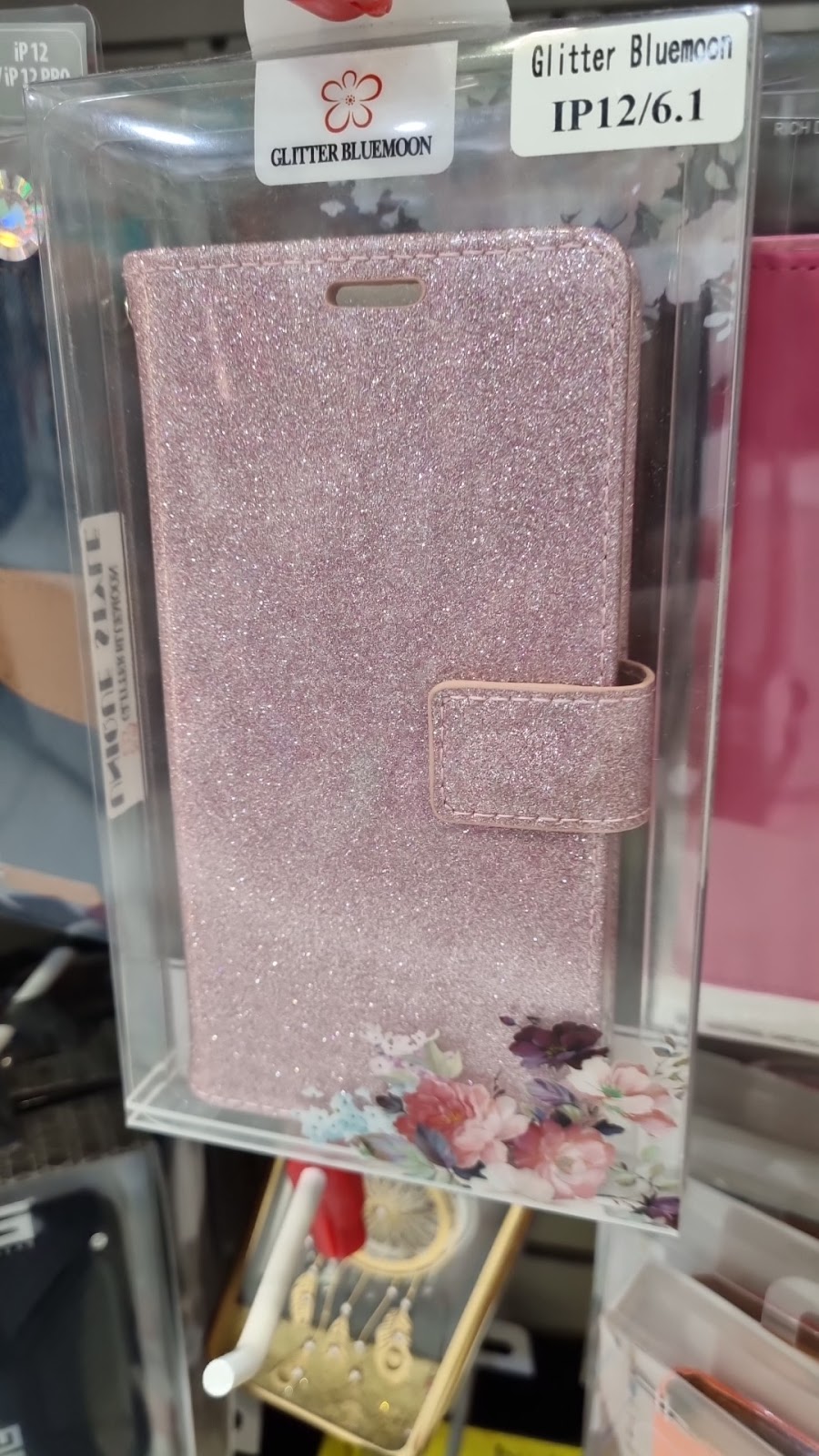 A pink glitter wallet case on the display hook